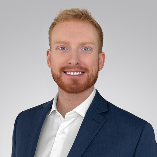 Professional headshot of Daniel Charles, Behavioral Scientist at Lotis Blue Consulting, wearing business attire and smiling against a neutral background.